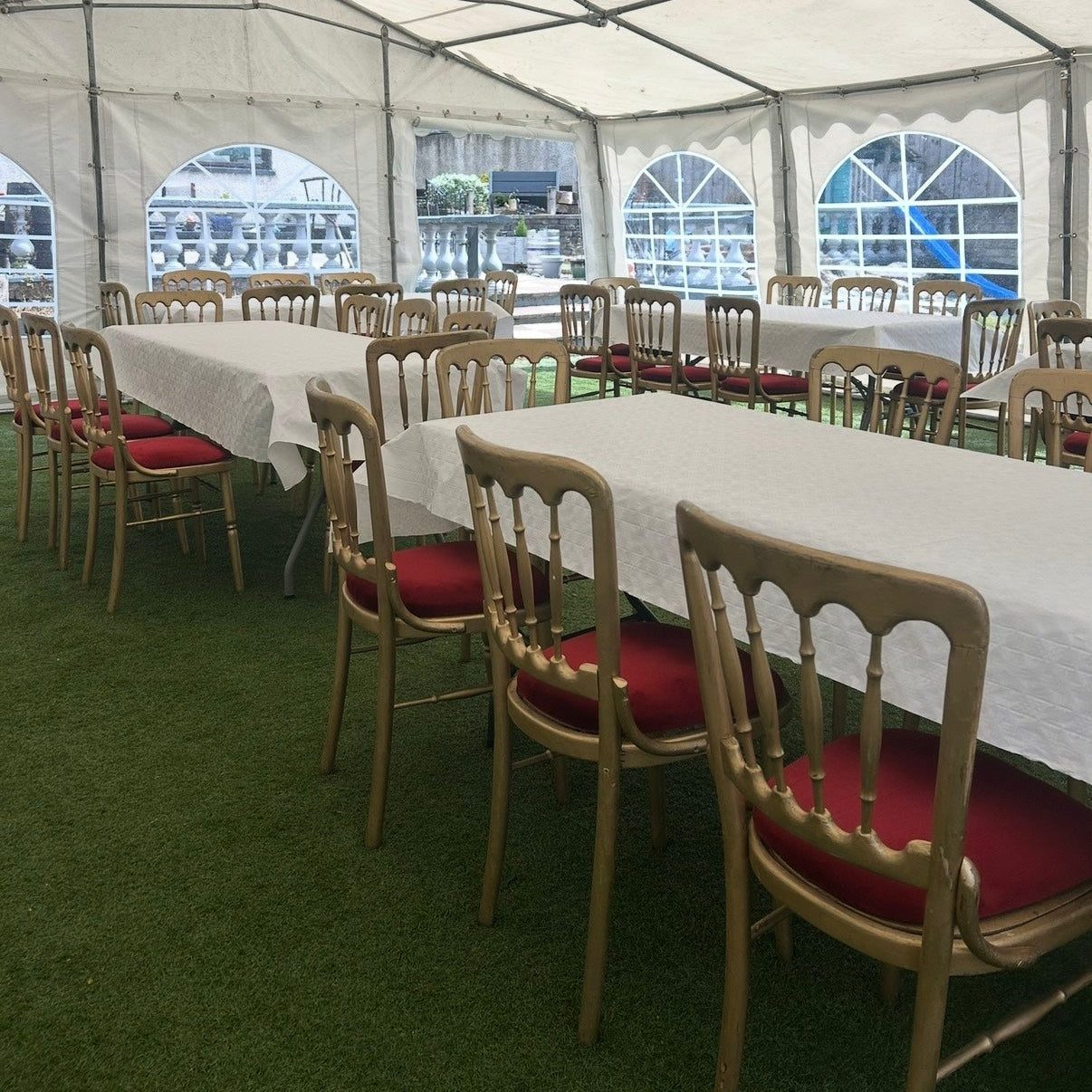 Event tent with tables and chairs set up for an indoor gathering.
