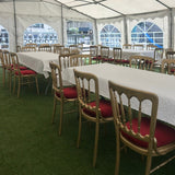 Event tent with tables and chairs set up for an indoor gathering.