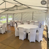 Event tent with white tables and chairs set up for an outdoor gathering.