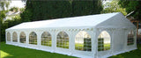 White party tent with arched windows on a grassy area